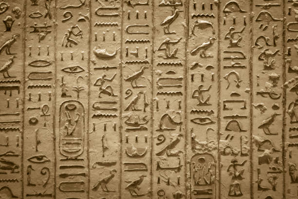 Hieroglyphics of ancient Egypt carved on sandstone wall stock photo