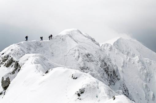team of alpinism on the ridge of a mountain
