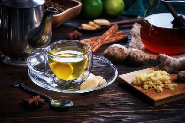 High angle close-up view of a cup of hot tea ginger infusion on a table in a rustic kitchen stock photo