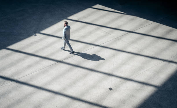 High angle view of a businessman walking outdoors stock photo