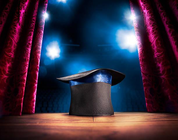 High contrast image of magician hat on a stage photo composite of a magic hat on a stage magician stock pictures, royalty-free photos & images