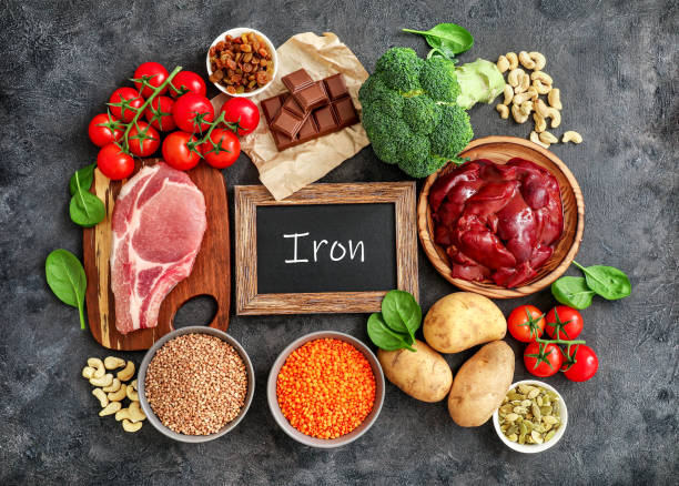 High in Iron sources assortment Assortment of high in Iron sources on dark background: liver, beef, raisins, keshew, buckwheat, spinach, tomatoes, potatoes, dark chocolate, pumpkin seeds, lentil, broccoli. Top view. liver offal photos stock pictures, royalty-free photos & images