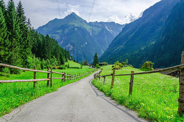 High peaks of the Alps with coutry road,  Austria stock photo