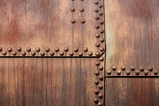 Weathered metal background with rivets, part of an old tank wagon.