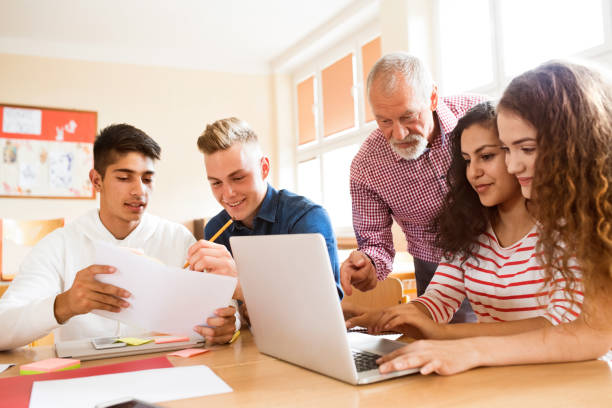 High school students and teacher with laptop. Group of high school student and their teacher with laptop studying. high school building stock pictures, royalty-free photos & images