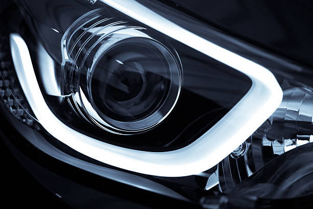 LED highlight for a new black car Detail on one of the LED headlights of a car. headlight stock pictures, royalty-free photos & images