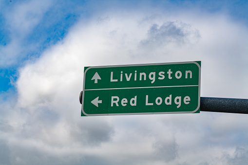 Highway sign with arrow to Livingston and Red Lodge in small town Montana in western United States of America (USA).