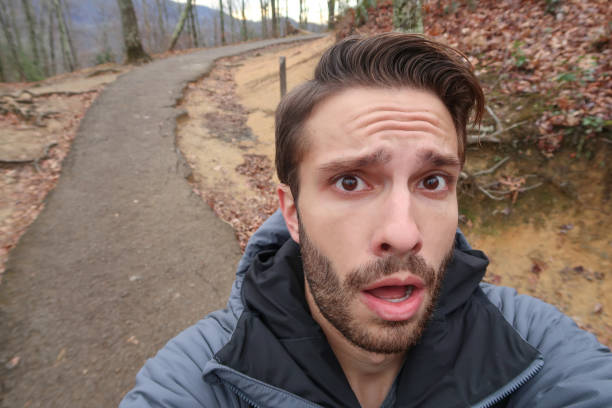 A hiker makes a surprised face at camera stock photo