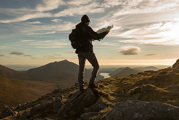 Hiker with map, Mourne Mountains, Northern Ireland Hiker with map, Mourne Mountains, County Down, Northern Ireland northern ireland stock pictures, royalty-free photos & images