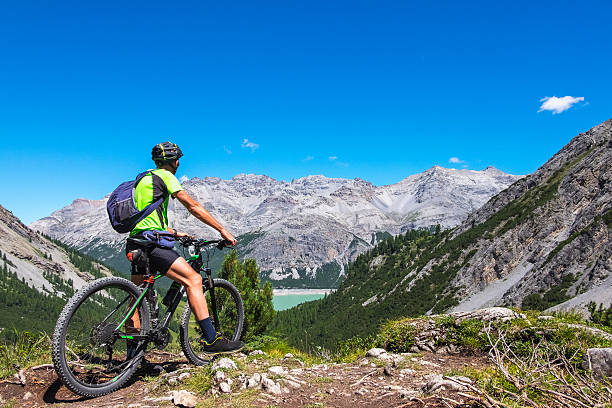 Hiker with mountain bike stock photo