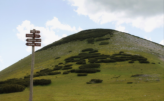 Directional signposts with distances for hikers high in the mountain