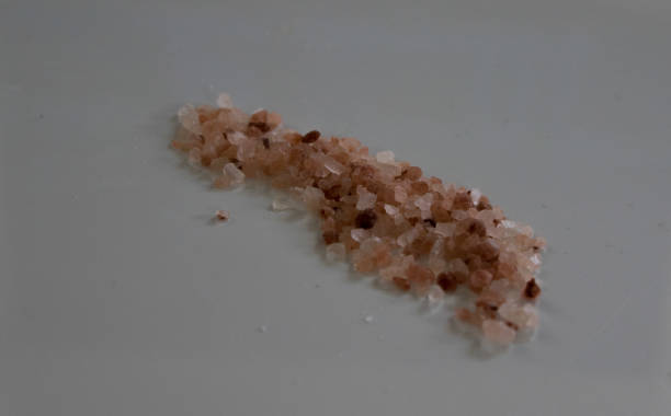 Himalayan rock salt spread across a plate stock photo
