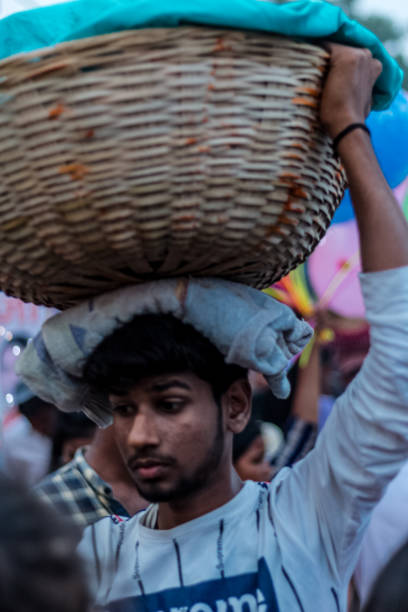 Hindu Devotees Celebrate Chhath Puja Festival Ghaziabad, Uttar Pradesh/India - Nov 2019 : Devotees carrying fruits and other stuff on their head to celebrate the festival of Chhath Puja at Hindon river chhath stock pictures, royalty-free photos & images