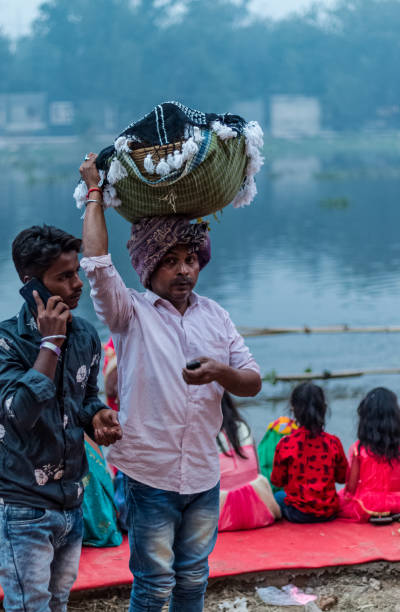 Hindu Devotees Celebrate Chhath Puja Festival Ghaziabad, Uttar Pradesh/India - Nov 2019 : People gather to worship the Sun god at Hindon River during the festival of Chhath Puja chhath stock pictures, royalty-free photos & images