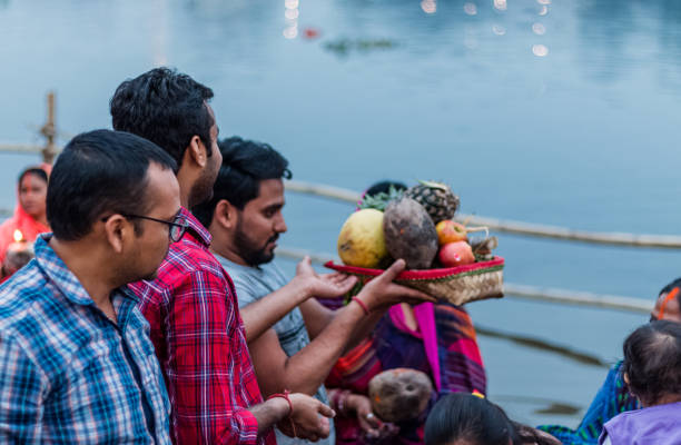 Hindu Devotees Celebrate Chhath Puja Festival GHAZIABAD, Uttar Pradesh/India - NOVEMBER 2019 : People gather to worship the Sun god at Hindon River during the festival of Chhath Puja chhath stock pictures, royalty-free photos & images