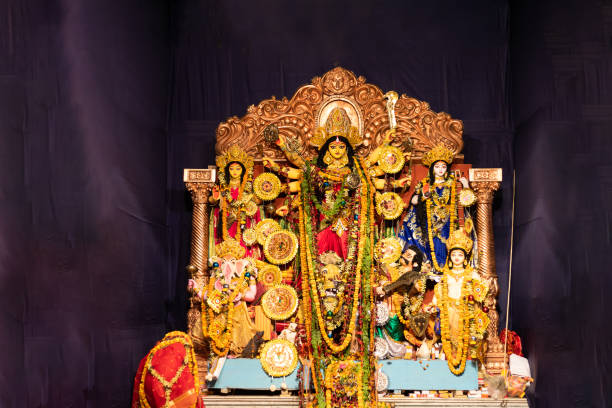 Hindu Goddess Durga during Durga Puja Celebrations. An Idol of Hindu goddess Durga placed in a temporary shed made out of canvas and bamboo, and is decorated with colorful cloths called as Pandal for worship, The deity made out of clay is adorned with decorative work. Durga Puja ,also called Durgotsava  is an annual Hindu festival originating in the Indian subcontinent, mainly in West Bengal and Kolkata which reveres and pays homage to the Hindu goddess, Durga. hindu god stock pictures, royalty-free photos & images