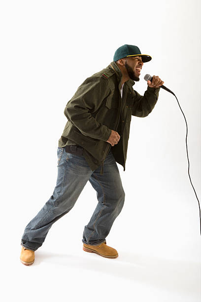 A hip hop artist singing into a microphone stock photo