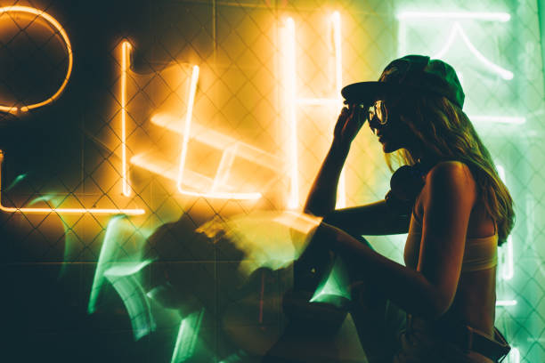Hip-hop girl in cap. Hip-hop girl in cap in neon light. Fashion portrait of modern young woman in cap. rapper stock pictures, royalty-free photos & images