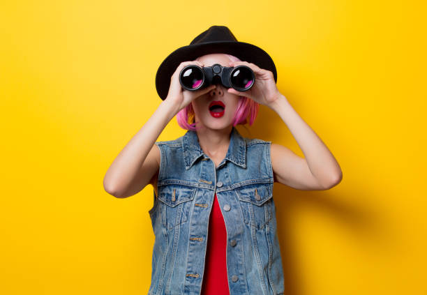 hipster girl with pink hair style with binoculars stock photo