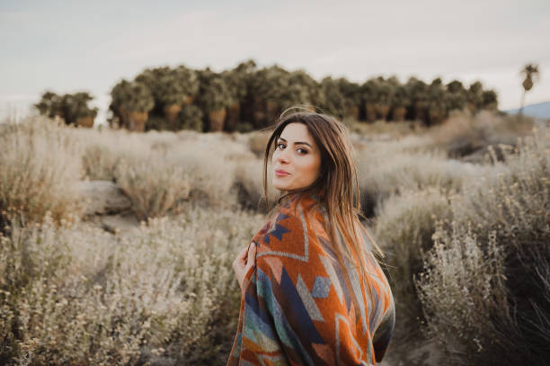 Hipster girl with windy hair in the desert nature Boho woman in the desert nature.  Artistic photo of young hipster traveler girl in gypsy look, vlad model photos stock pictures, royalty-free photos & images