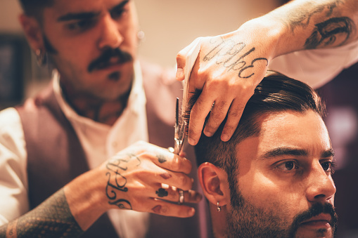 Hipster Man Getting Trendy Hairstyle By Stylish Barber With