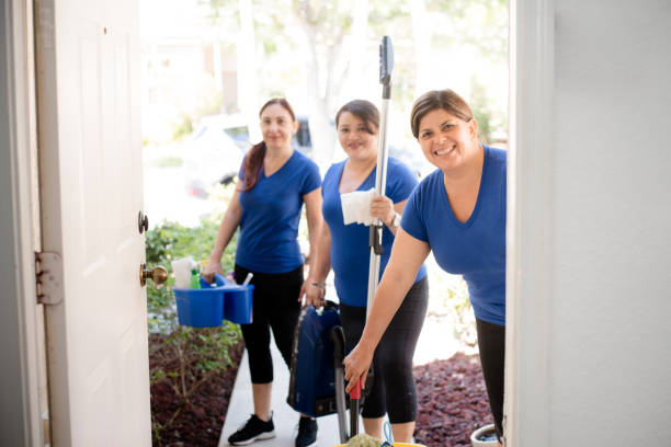 Hispanic cleaning ladies Cleaning ladies working in team arriving at a house maid stock pictures, royalty-free photos & images