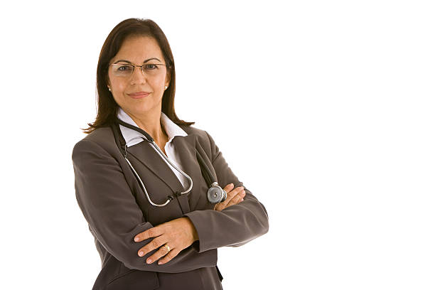 Hispanic female doctor with stethoscope in suit arms crossed stock photo