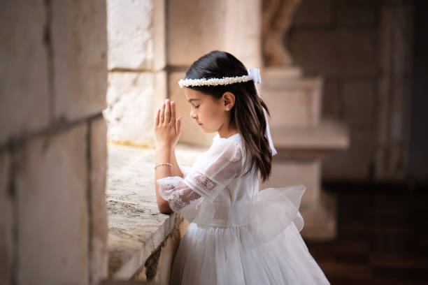 Hispanic girl praying stock photo
