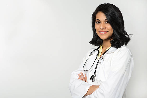 Hispanic Health Care Professional Hispanic doctor smiling. female doctor stock pictures, royalty-free photos & images