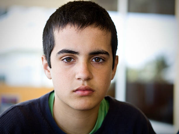 hispanic teenage boy close up close up picture of a hispanic teenage-boy (this picture has been taken with a Hasselblad H3D II 31 megapixels camera) blank expression stock pictures, royalty-free photos & images