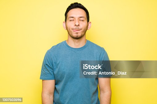 istock Hispanic young man thinking about delicious food 1307503596