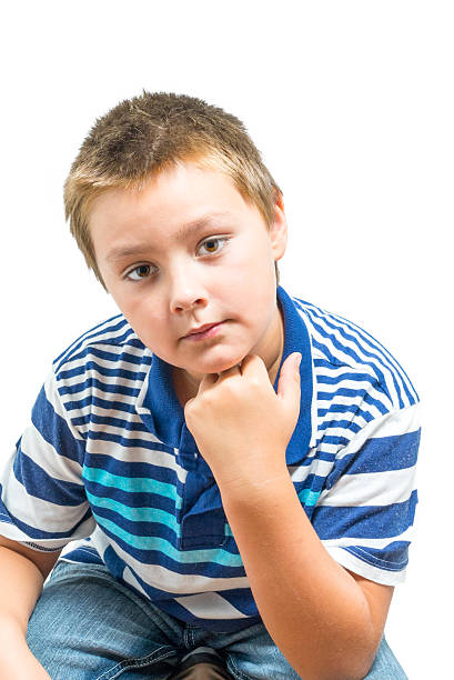 Hispanic-American Child Rests Chin On Hand During Picture stock photo
