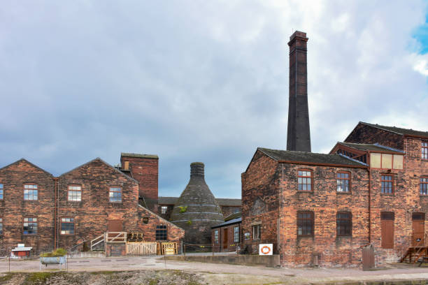 Historic buildings of potteries with bottle oven located on banks of Trent and Mersey canal in Stoke on Trent, Staffordshire,Uk. stock photo