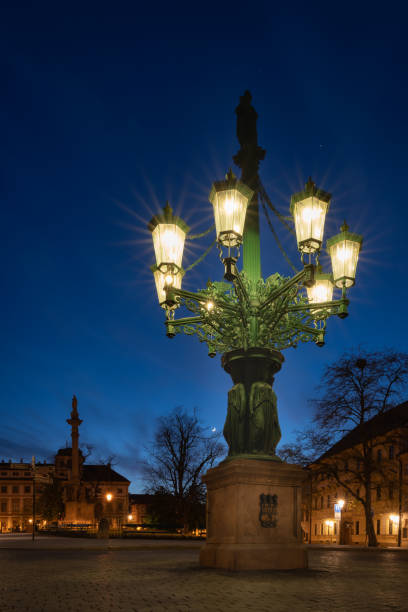 Historic gas street lamp on a Castle square in Prague, Czech Republic. Beautiful ornamental candelabra with 8 arms, technical monument made of cast iron in 1876  prague art stock pictures, royalty-free photos & images