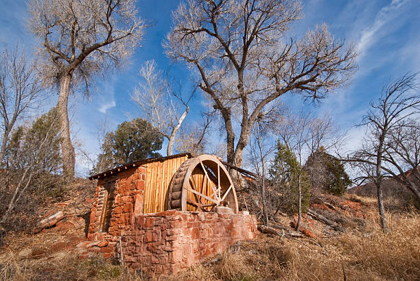 Historic Power Generating Water Wheel In the 1930's the owners of Crescent Moon Ranch installed a water wheel in their irrigation ditch. Falling water spun the wheel, driving a water pump and an electric generator. This system pumped water to storage tanks and brough power to the ranch. Crescent Moon Ranch is in the Coconino National Forest near Sedona, Arizona, USA. jeff goulden sedona stock pictures, royalty-free photos & images