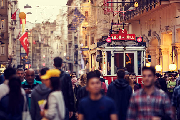 historic red tram on crowded istiklal avenue in taksim, istanbul - beyoglu stockfoto's en -beelden