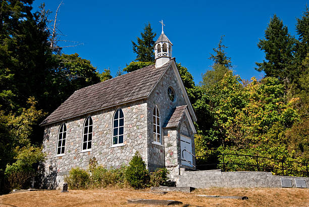 Historic Stone Church The Canadian Gulf Islands are part of a rocky archipelago in the Strait of Georgia between Vancouver Island and the mainland of British Columbia. The larger archipelago includes the San Juan Islands in the United States. The Gulf Islands are perhaps best known for their natural beauty, farms, wineries, rural lifestyle and Mediterranean climate. Activities to be enjoyed in the Gulf Islands includes boating, kayaking, hiking, camping and wildlife viewing. This area was charted by British explorer George Vancouver during his 1791-1795 expedition. The name “Gulf Islands” comes from “Gulf of Georgia,” the original name used by Vancouver on his maps. This scene was photographed at Saint Paul's Catholic Church (1880) near Fulford on Saltspring Island, British Columbia, Canada. jeff goulden church stock pictures, royalty-free photos & images