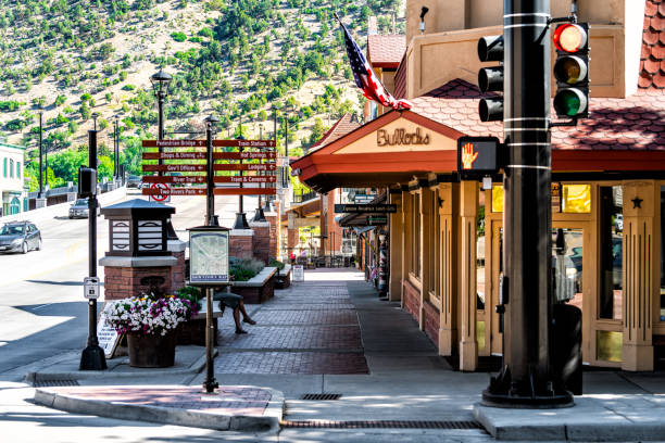 Historic street sidewalk in Colorado on Grand Avenue and Bullocks sign for clothing store Glenwood Springs, USA - July 10, 2019: Historic street sidewalk in Colorado on Grand Avenue and Bullocks sign for clothing store garfield county utah stock pictures, royalty-free photos & images