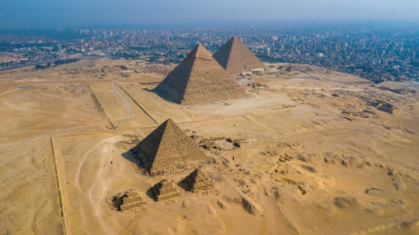 Historical Giza pyramids in Egypt shot by drone. Historical Giza pyramids in Egypt shot by drone. archaeology photos stock pictures, royalty-free photos & images