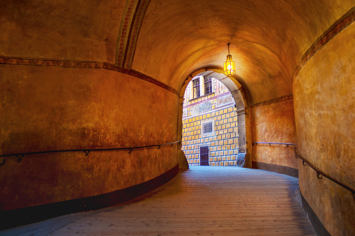 historical passage between the castle courtyards, lit by lantern - Castle Cesky Krumlov, Czech republic