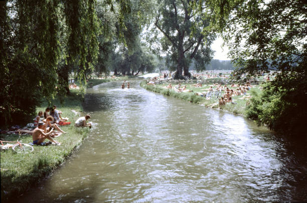 Historical photograph of the English Garden in Munich Munich, Germany, September 7, 1986 - Historical photograph of unidentified people relaxing in the English Garden within the "Nacktbadegelaende". river isar stock pictures, royalty-free photos & images