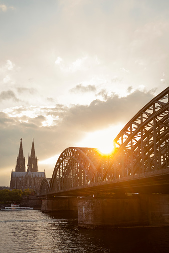 Hohenzollern Bridge and Cathedral illuminated at night, Cologne, Germany