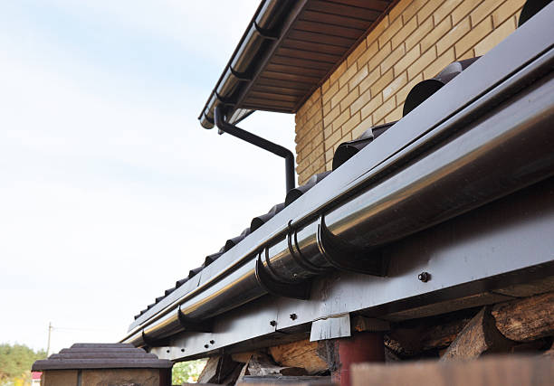Holder gutter drainage system on the roof. Holder gutter drainage system on the roof. Closeup of problem areas for plastic rain gutter waterproofing. roofing solutions stock pictures, royalty-free photos & images