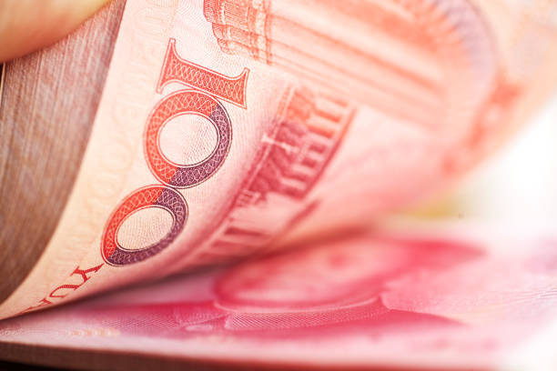 Holding a stack of chinese mone Details of a stack of one hundred yuan notes .Chinese currency. chinese currency stock pictures, royalty-free photos & images