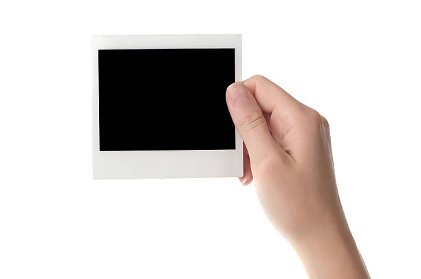 holding blank instant photo Women hand holding blank photo frame isolation on white background hand photos stock pictures, royalty-free photos & images