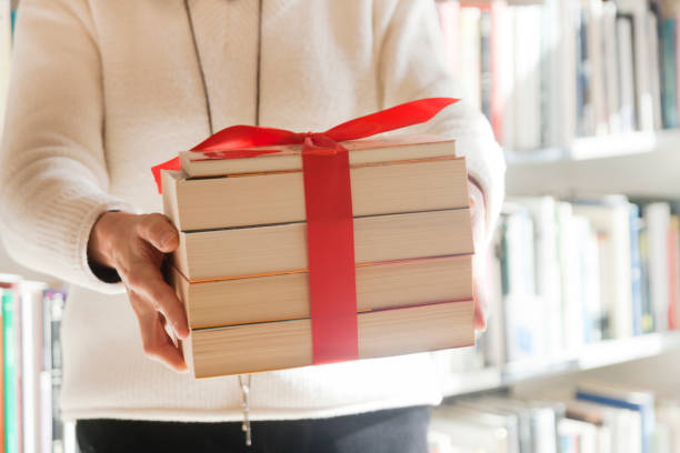 Holding books with bow stock photo