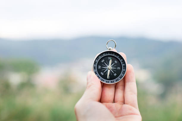 holding compass to orientate stock photo