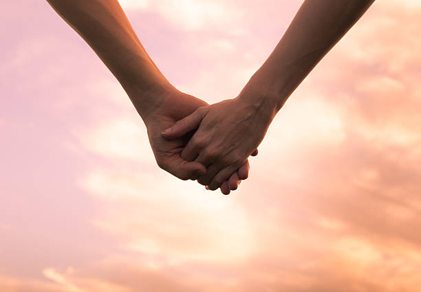 Holding hands stock photo