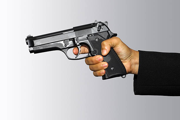 Holding pistol stock photo