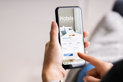 Holding Smart Phone Booking Hotel Online Using Website